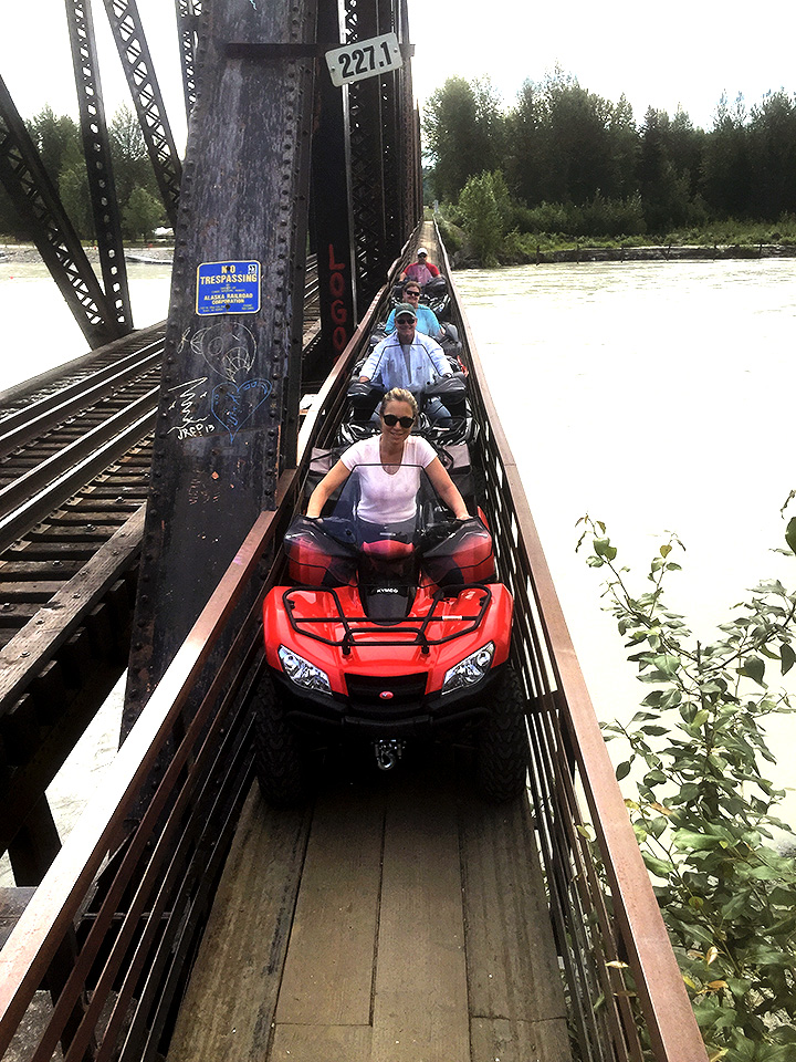 All terrain vehicles crossing the bridge